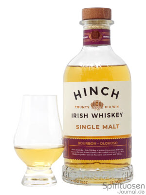 eine Flasche Hinch Single Malt nebst Glas
